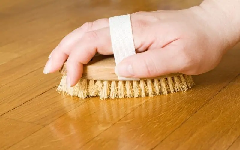 man scrubbing wood floor
