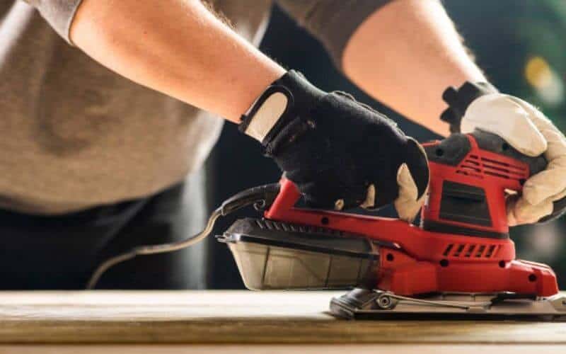 sanding floor with hand belt sander
