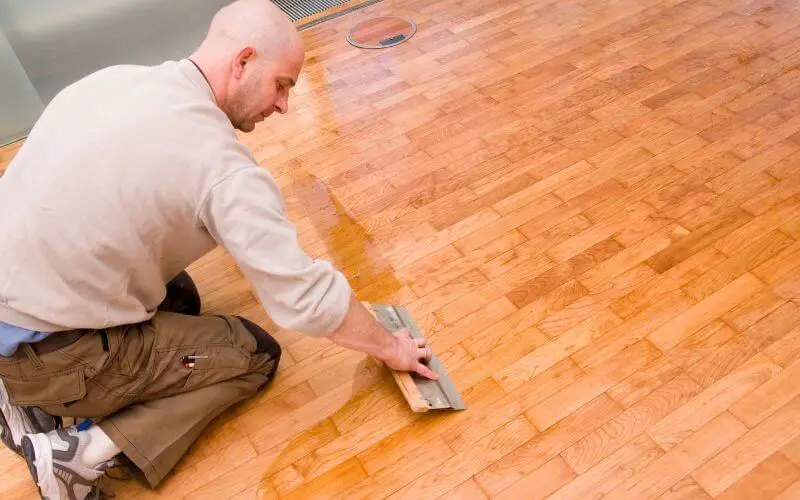 man waxing wood floor