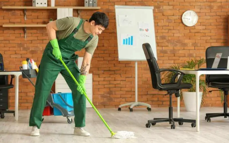 man mopping a concrete floor