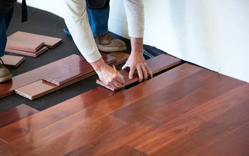 Installing hardwood floors around kitchen cabinets